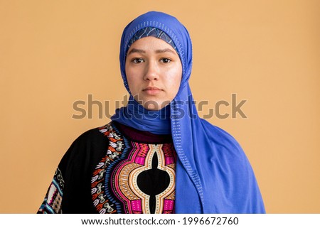 Young Muslim woman in a blue hijab Royalty-Free Stock Photo #1996672760