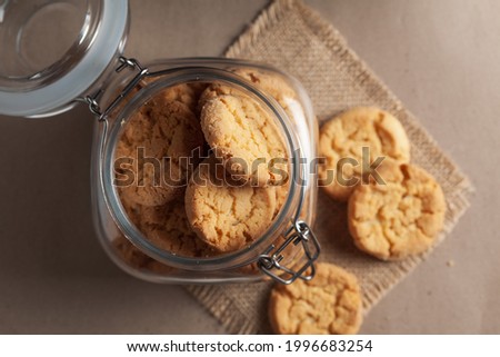 Close-up of delicious freshly baked simple cookies or biscuits  in glass airtight containers. Royalty-Free Stock Photo #1996683254