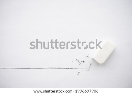 Flat lay of white eraser delete black line pencil on white paper background copy space. Repair, remove, creative idea, imagination and education concept. Royalty-Free Stock Photo #1996697906