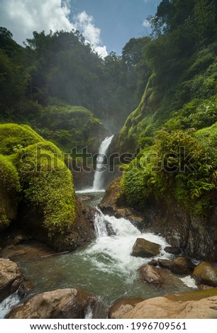 Morning atmosphere at Uci Waterfall located in South Garut, West Java, Indonesia. This photo was taken on March 21, 2021 Royalty-Free Stock Photo #1996709561