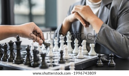 Two business women competitors playing chess board game, business competition concept, business plan to be the number one company, competitor analysis and problem solving. For always good results. Royalty-Free Stock Photo #1996743809
