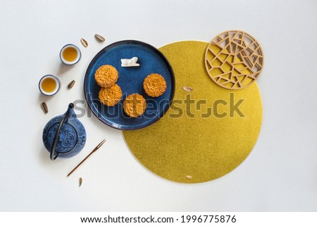 Flat lay mid autumn festival mooncake and tea still life on white textured background. Royalty-Free Stock Photo #1996775876