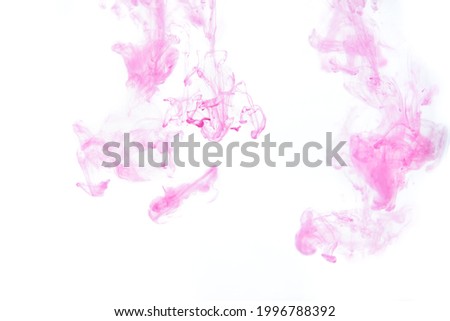 Bright pink purple acrylic paint swirling in water. Ink moving in liquid creating abstract clouds. Traces of colorful dissolving in water, changing shape. Abstract decorative creative background.