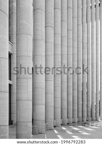 composite column structure supporting airport building roof. Architecture black and white background classic building with columns.