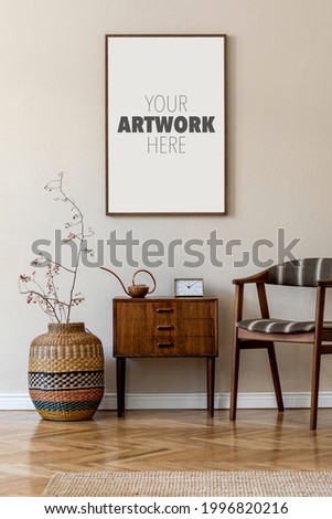 Modern composition of living room interior with brown mock up poster frame, design retro commode, chair, etno basket with flower and elegant accessories. Template. Stylish home staging. Japandi.