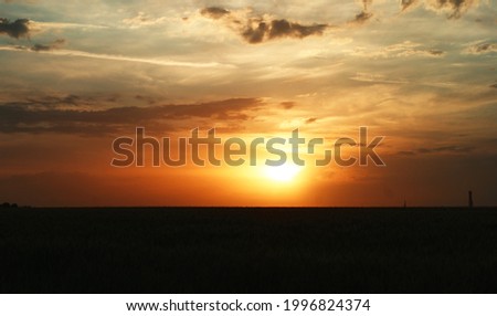 Dramatic sunset and sunrise sky with colorful and rainy clouds Royalty-Free Stock Photo #1996824374