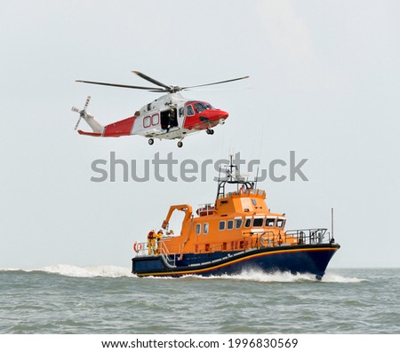 Rescue boat with Rescue Helicopter Royalty-Free Stock Photo #1996830569