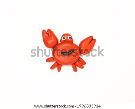 red plasticine crab on a white background
