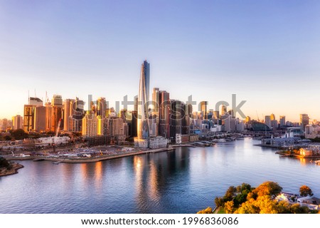 Barangaroo modern urban high-rise towers in city of Sydney CBD on Harbour shore - aerial view from Balmain at sunrise.