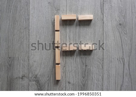 letter F with wooden natural blocks, construction , game for kids , no stress with wooden blocks, background