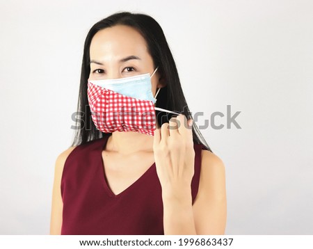 Portrait of Asian woman wearing  double or two face mask to protect from coronavirus or covid-19 outbreak - concept of safety, healthcare, medical and hygiene.