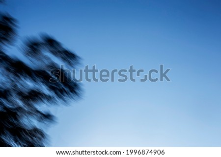 Hazy shadow streak pattern on gradient blue and white sky 