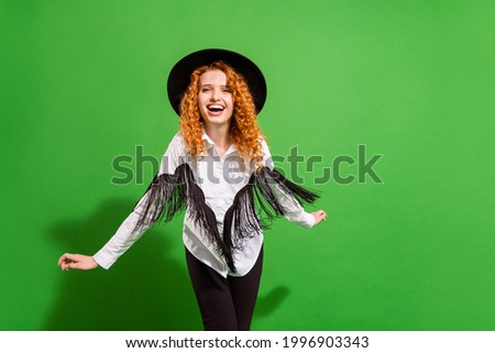 Portrait of attractive cheerful wavy-haired girl having fun resting dancing holiday isolated over bright green color background