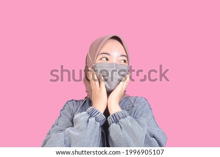 Asian girl wearing masker with pink background Royalty-Free Stock Photo #1996905107
