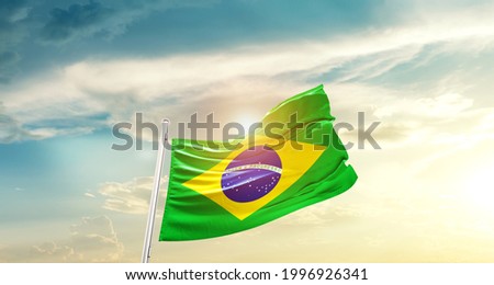 Brazil national flag waving in beautiful clouds. Royalty-Free Stock Photo #1996926341