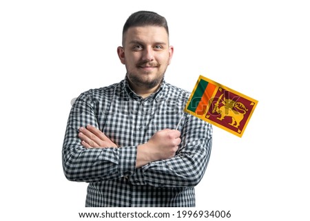 White guy holding a flag of Sri Lanka smiling confident with crossed arms isolated on a white background.