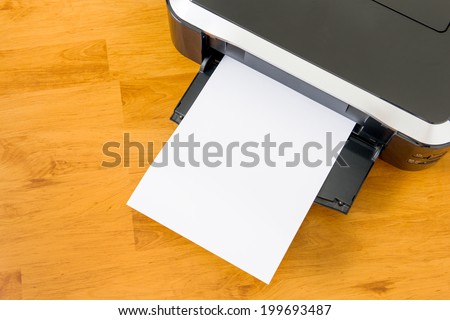 Printer and paper on wooden board