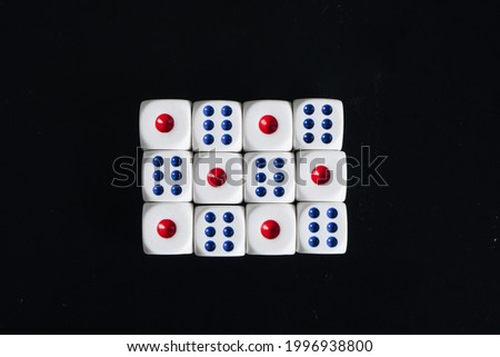 Colorful dice isolated on black background (flat lay style)