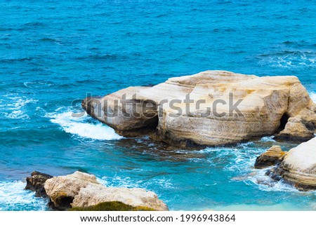 Ocean waves splash against beach with rocks background, Cliffs in the sea, Top aerial view of Cyprus, Nature Background with Ocean, Vacation and relax in a secluded place
