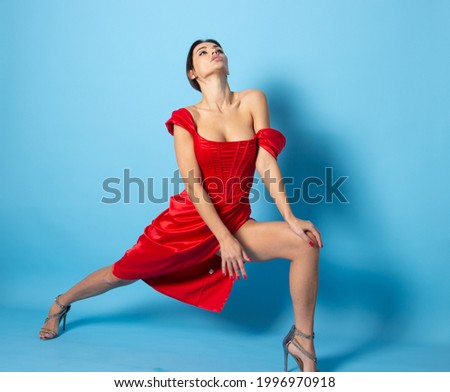beautiful woman posing in red dress