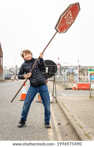 An english boy with traffic sign in England, UK