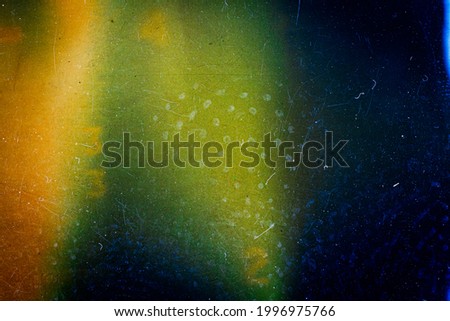 Abstract colorful scratched film texture background with heavy grain, dust and light leak