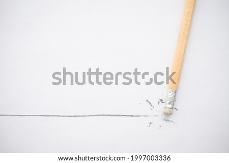 Flat lay of pencil eraser delete black line pencil on white paper background copy space. Repair, remove, creative idea, imagination and education concept. Royalty-Free Stock Photo #1997003336