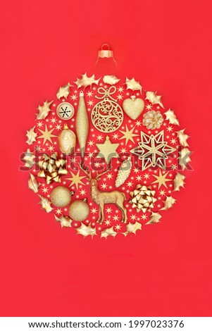Christmas bauble shape with gold stars and decorations on red background. Flat lay, top view, copy space. Design element for the festive season.