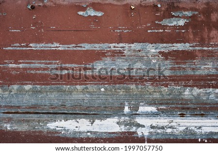 Worn out peeling paint on old metal sheet, grunge background or texture 