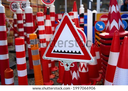 Shop of warning and restrictive road signs. Sign warning about a road blocker with spikes.