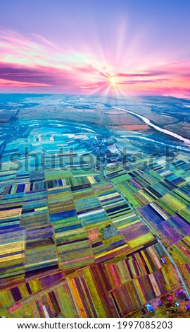 Eastern Europe, Ukraine, striped farm fields near the ancient city of Galich next to the large Dniester river, captured from a bird's eye view of a drone .