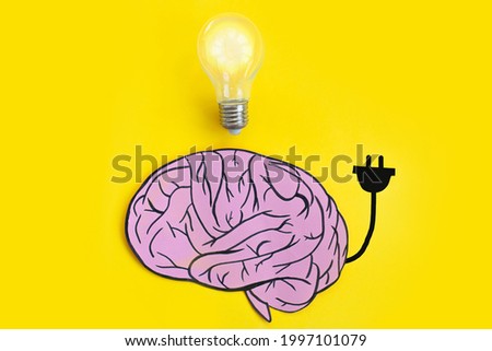 drawn cartoon human brain with plug and glowing light bulb on yellow background. creative concept brainstorm. business idea creation