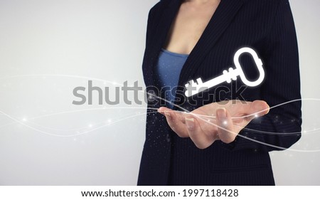 Key Keyword Icon Business concept. Hand hold digital key hologram on grey background. Safety and security concept