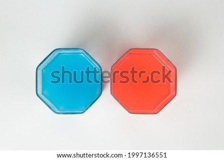 Red and blue. The symbol of the coronavirus vaccine. Faceted containers