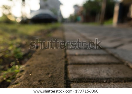 Defocused background of pavement and car