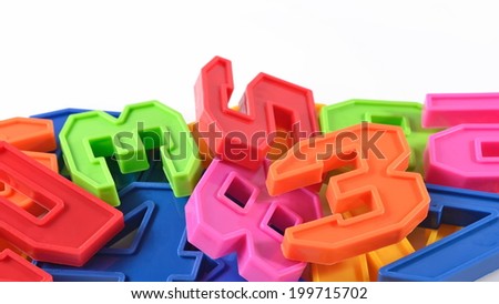Colorful plastic numbers on white background