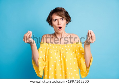 Photo portrait of angry girl showing italian hand sign isolated on vivid blue colored background