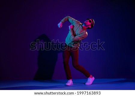 Full length body size photo guy overjoyed dancing party in night club enjoying music isolated violet color background