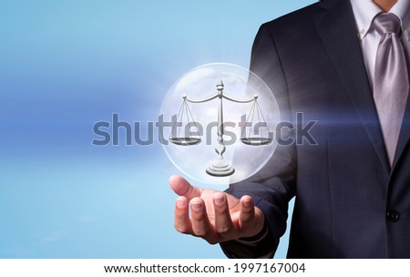 Businessman holding digital image of Scales of justice, Law and Justice concept.