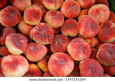 fig flat peaches. juicy ripe fig peaches fruit. red mature fig peaches background, agricultural products, sale in farmers market. Harvest season. top view, horizontal, vertical Royalty-Free Stock Photo #1997191004