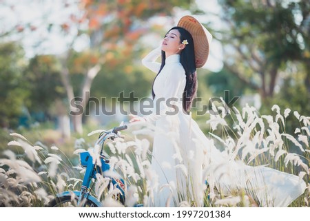 Ho Chi Minh City, Vietnam: a beautiful Vietnamese student in white ao dai  Royalty-Free Stock Photo #1997201384