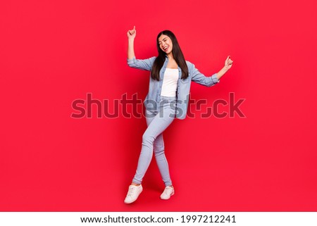 Full length body size view of lovely dreamy overjoyed cheerful carefree girl having fun dancing isolated over bright red color background
