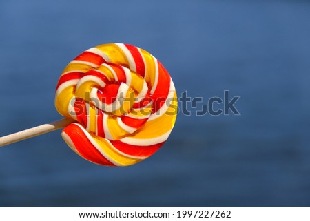 Colorful rainbow lollipop and nature background. High quality photo