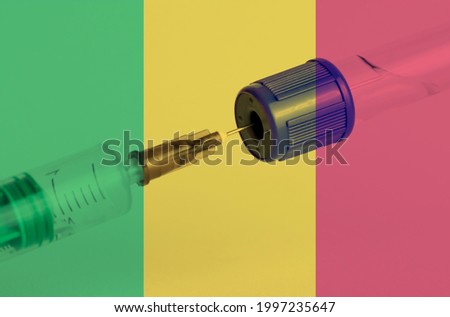 Mali flag on the background of a medical bottle for injection and syringe for vaccination. Coronavirus vaccine