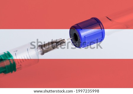 Austria flag on the background of a medical bottle for injection and syringe for vaccination. Coronavirus vaccine
