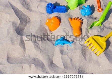 Flat lay composition with beach toys on sand. Summer time. Vacation