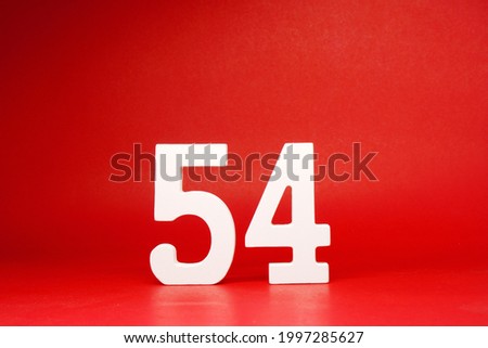 Fifty four ( 54 ) white number wooden Isolated Red Background with Copy Space - New promotion 54% Percentage , Business finance or birthday Concept - advertise banner picture online with copy space