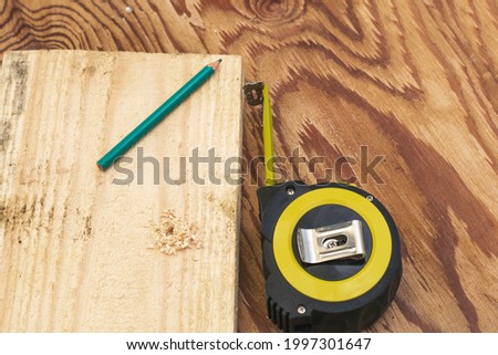 measuring tape pencil and fosca on the workbench concept craft construction. High quality photo