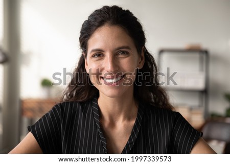 Close up profile picture of happy millennial Caucasian woman look at camera show leadership and success at workplace. Smiling young female talk speak on video webcam digital virtual call on app.