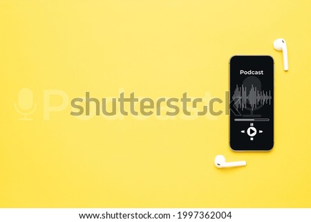 Podcast audio equipment. Audio microphone, sound headphones, podcast application on mobile smartphone screen. Recording sound voice on yellow background. Live online radio player mockup banner